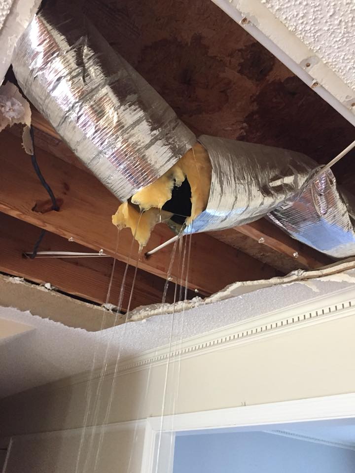 a ceiling with a pipe and a hole in it